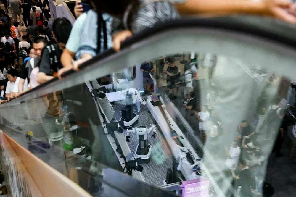 Cumulative spending globally on data centers alone could top $30 trillion by 2050, according to a projection by PwC, almost matching the value of outstanding US Treasuries. It "dwarfs" what was spent in the railroad or dotcom booms. File photo showing people visit the World Artificial Intelligence Conference (WAIC) in Shanghai, China, July 18, 2026. (Reuters)